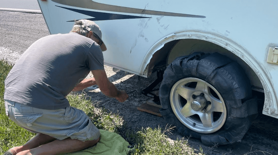 Blown tire and damage to the wheel well and fender