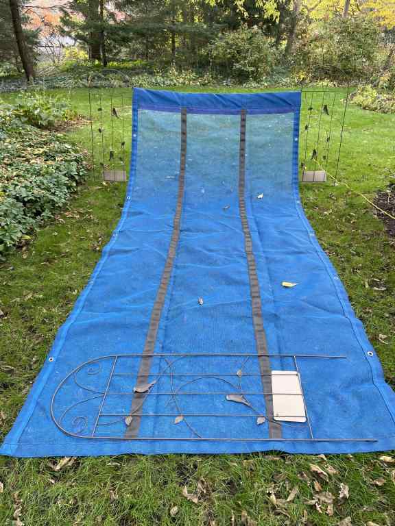 Tarp with one end elevated used to collect leaves