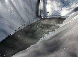 The above image shows water pooling on a tarp. The water slowly evaporates, leaving solids behind.